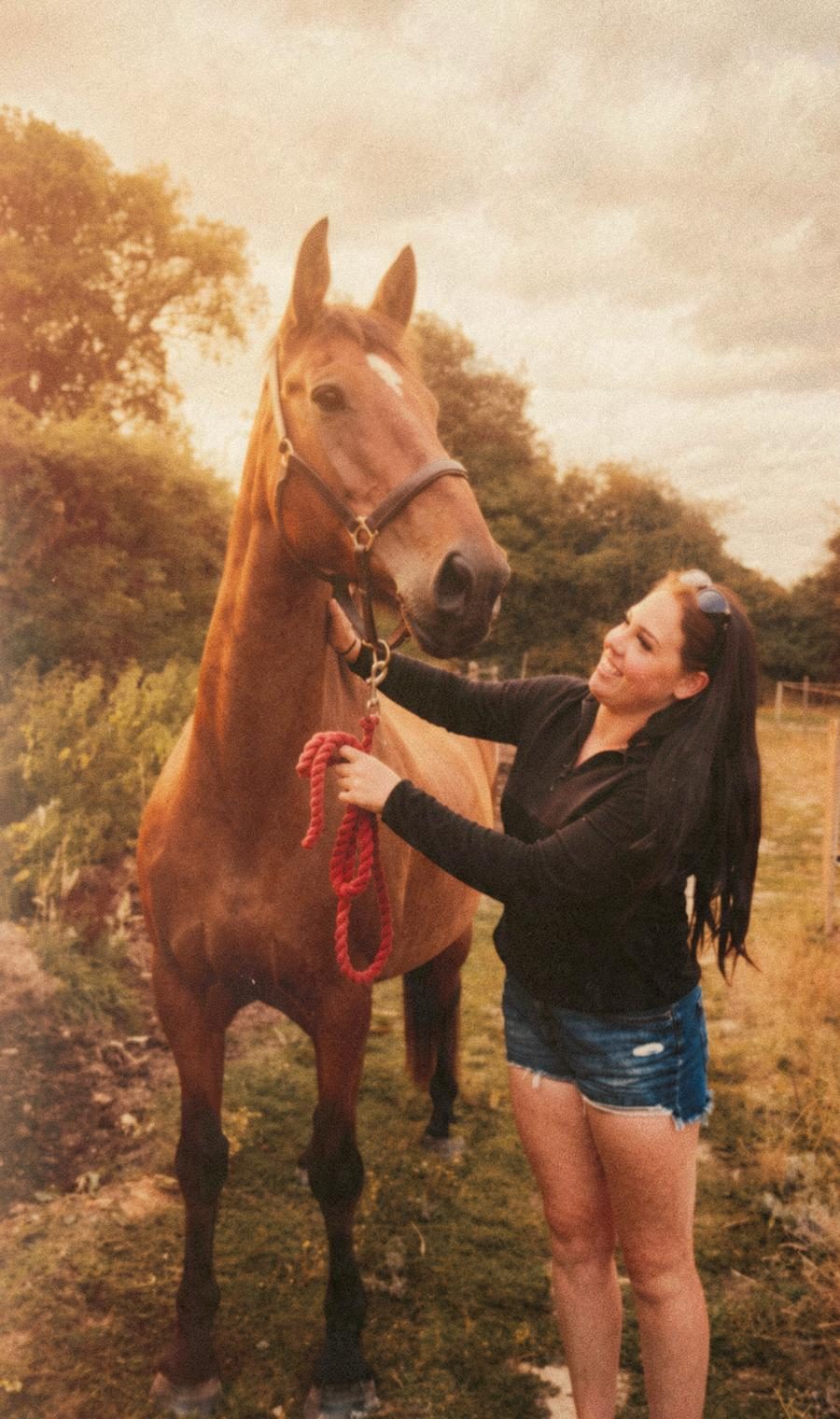 Aimee smiling up at Archie in the paddock